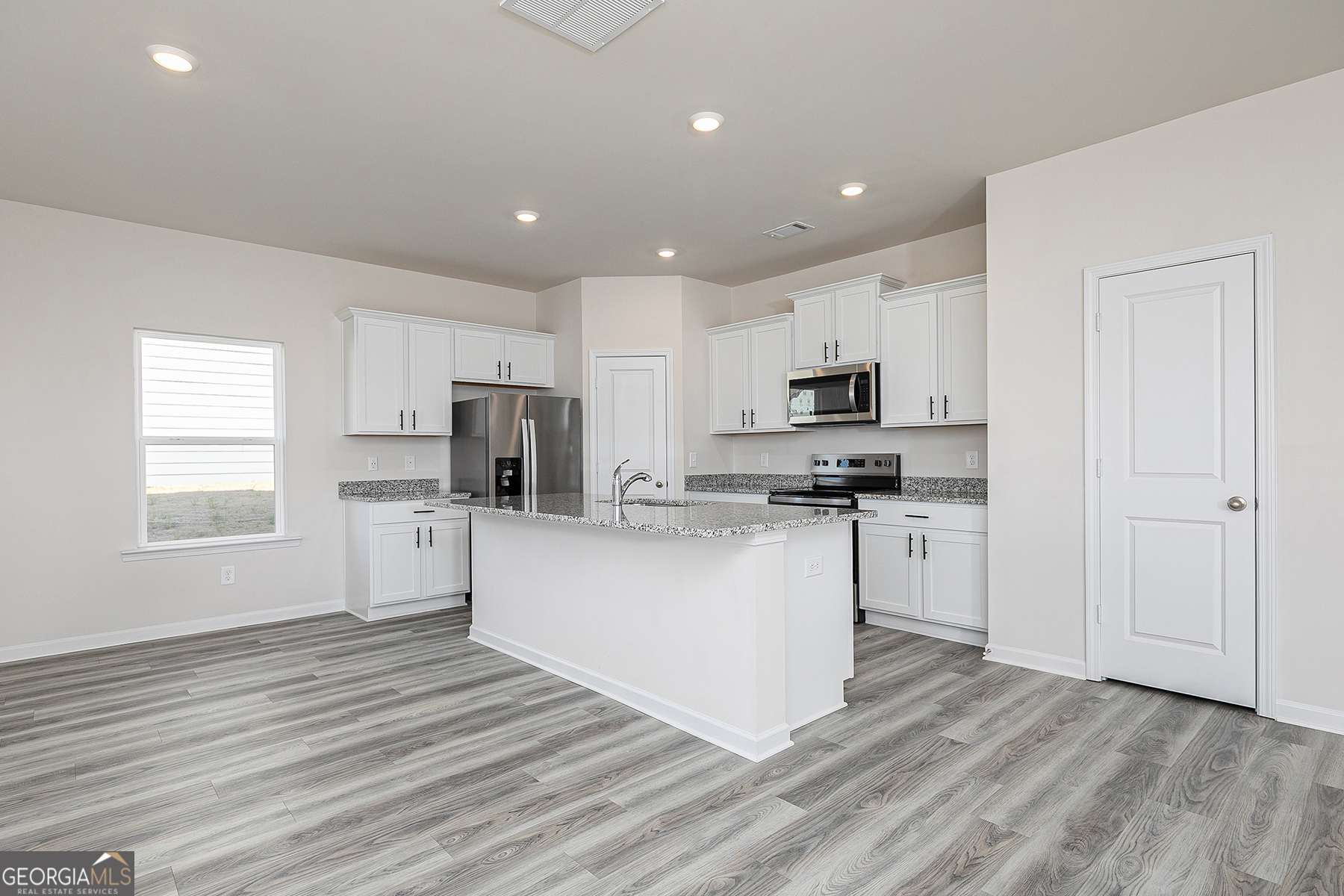 645 Mackenzie Cove Villa Rica, GA 30180 - Photo 7 of 20 a kitchen with granite countertop a refrigerator stove top oven and cabinets
