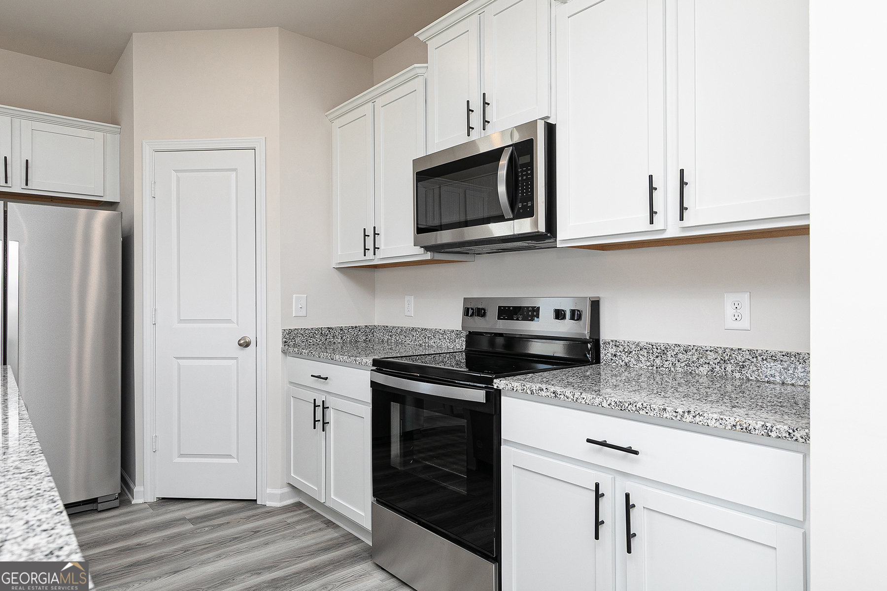 645 Mackenzie Cove Villa Rica, GA 30180 - Photo 9 of 20 a kitchen with stainless steel appliances granite countertop white cabinets and a microwave oven