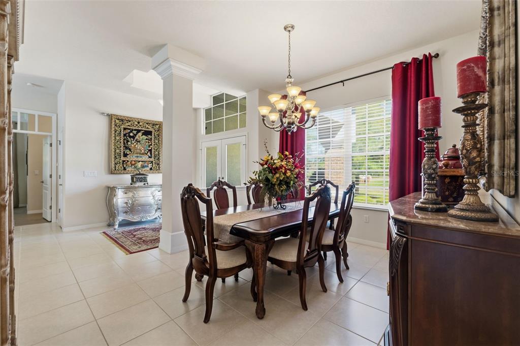 10260 Waters Edge Court Weeki Wachee, FL 34613 - Photo 16 of 58 a dining room with furniture a chandelier and window