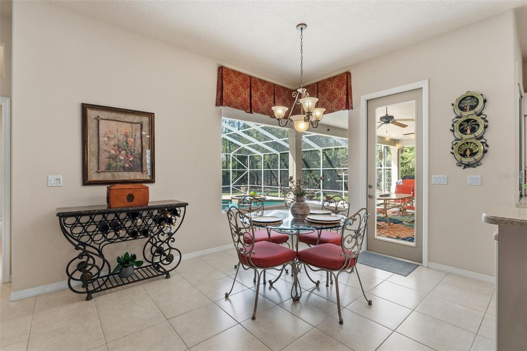 10260 Waters Edge Court Weeki Wachee, FL 34613 - Photo 22 of 58 a view of a dining room with furniture wooden floor and chandelier