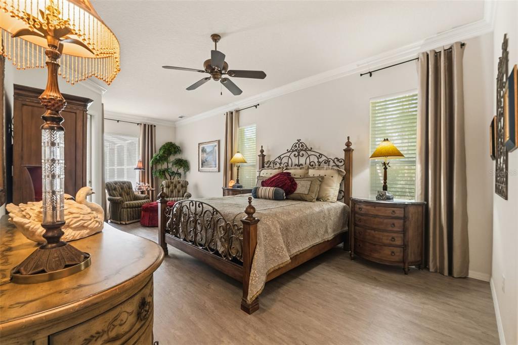 10260 Waters Edge Court Weeki Wachee, FL 34613 - Photo 28 of 58 a bedroom with a bed and wooden floor