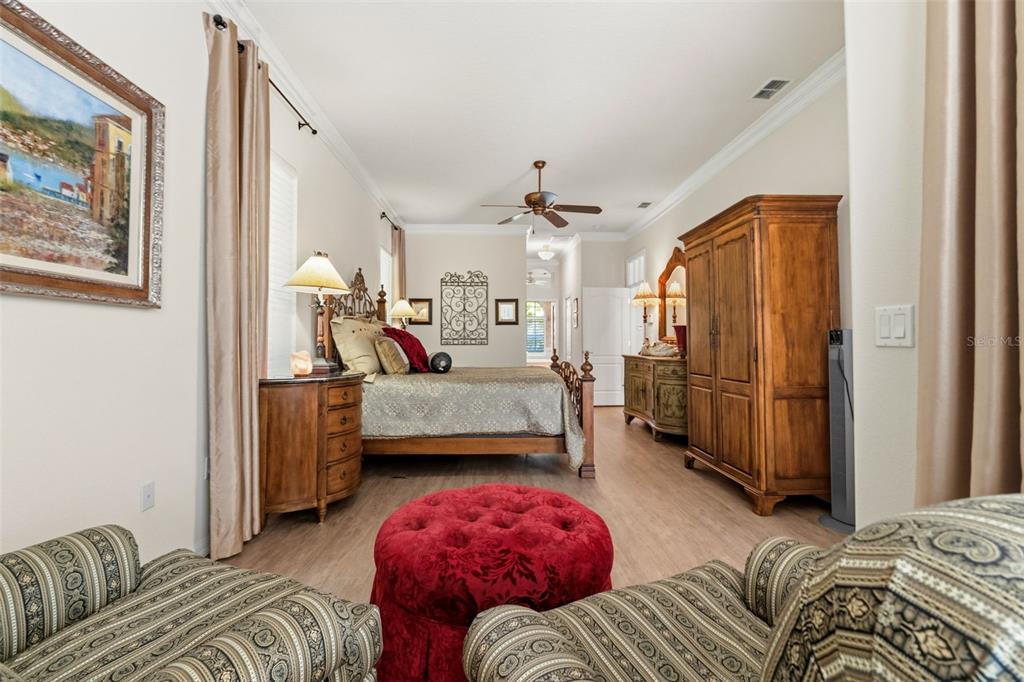 10260 Waters Edge Court Weeki Wachee, FL 34613 - Photo 30 of 58 a bedroom with furniture and a chandelier