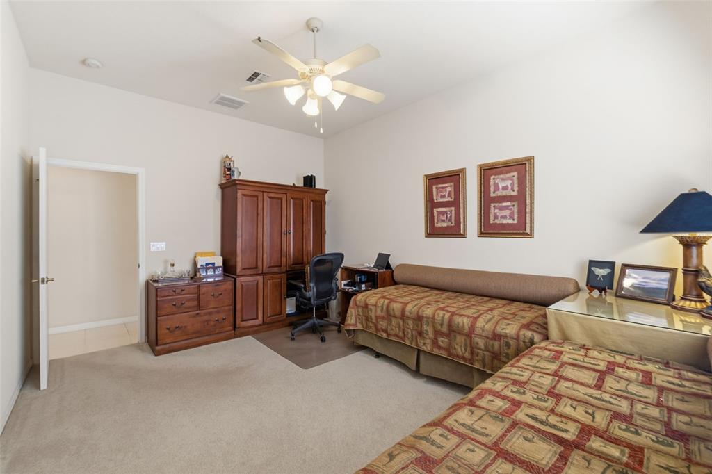 10260 Waters Edge Court Weeki Wachee, FL 34613 - Photo 36 of 58 a bedroom with two beds and painting on the wall