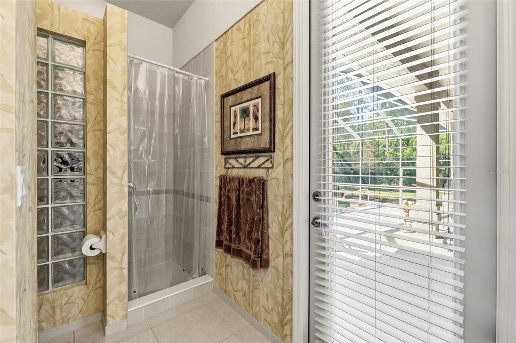 10260 Waters Edge Court Weeki Wachee, FL 34613 - Photo 38 of 58 a bathroom with a shower and a window
