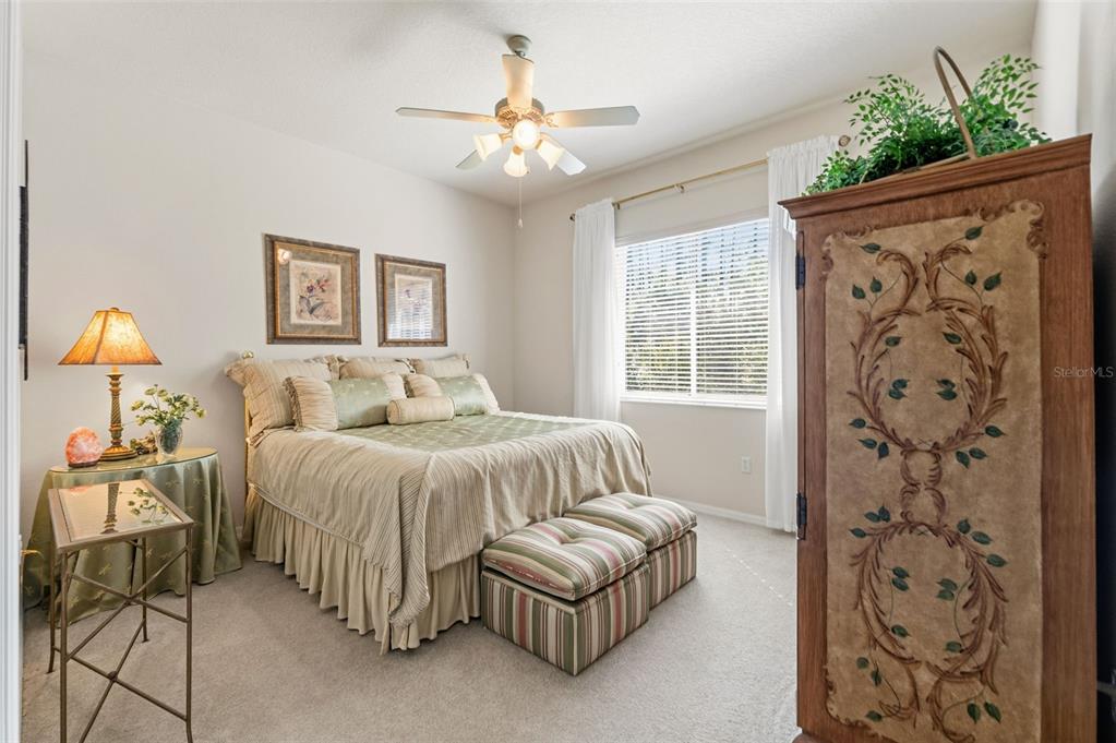 10260 Waters Edge Court Weeki Wachee, FL 34613 - Photo 40 of 58 a bedroom with a bed and a chandelier
