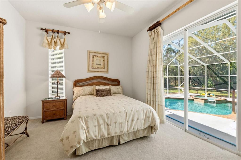 10260 Waters Edge Court Weeki Wachee, FL 34613 - Photo 42 of 58 a bedroom with a bed and a large window
