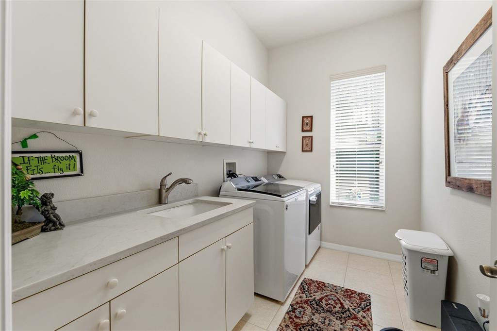 10260 Waters Edge Court Weeki Wachee, FL 34613 - Photo 44 of 58 a view of a kitchen with a sink and dishwasher a stove with wooden floor
