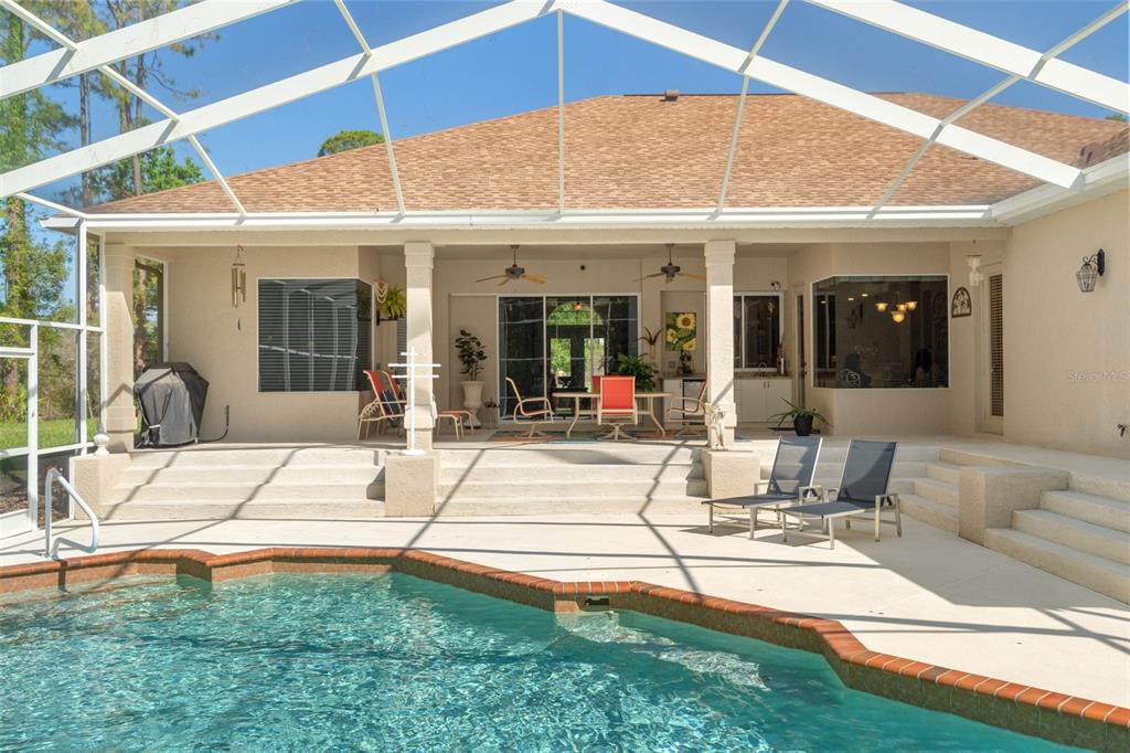 10260 Waters Edge Court Weeki Wachee, FL 34613 - Photo 50 of 58 a view of a patio with table and chairs with wooden floor and fence