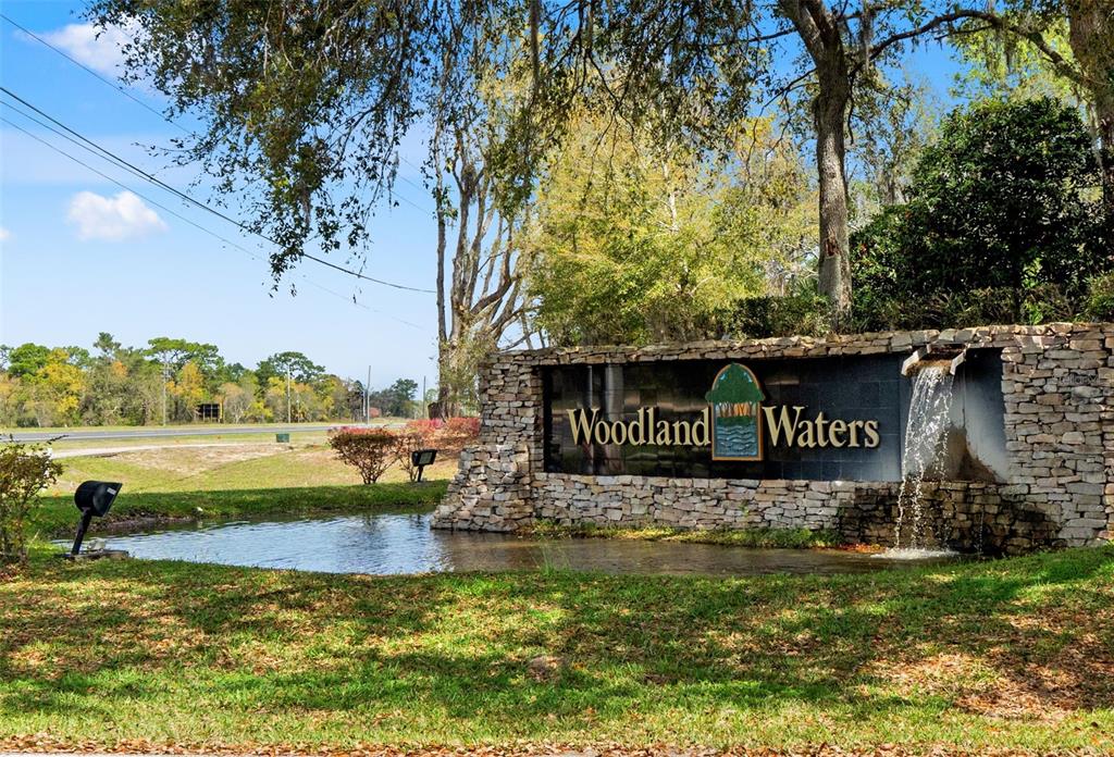 10260 Waters Edge Court Weeki Wachee, FL 34613 - Photo 58 of 58 a view of a street sign under a large tree