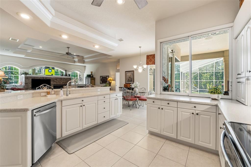10260 Waters Edge Court Weeki Wachee, FL 34613 - Photo 7 of 58 a kitchen with white cabinets and white appliances