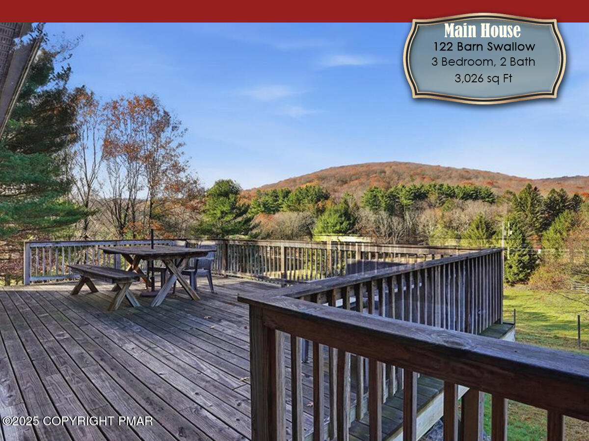 130 Barn Swallow Lane Cresco, PA 18326 - Photo 26 of 98 a view of a roof deck with table and chairs with wooden floor