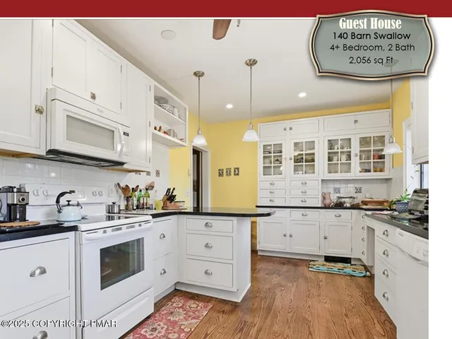 an aerial view of a house with a garden and swimming pool
