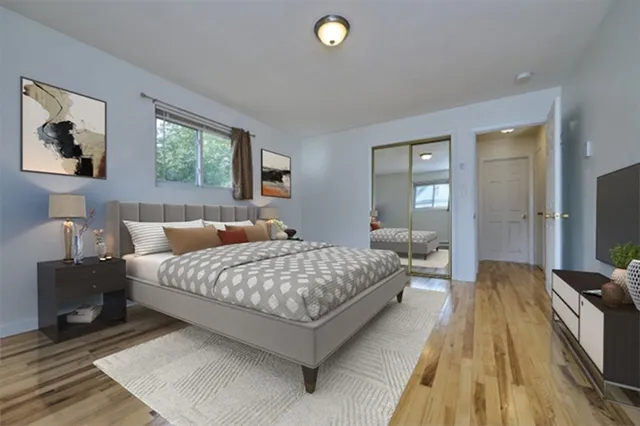 a bedroom with a bed and a flat screen tv