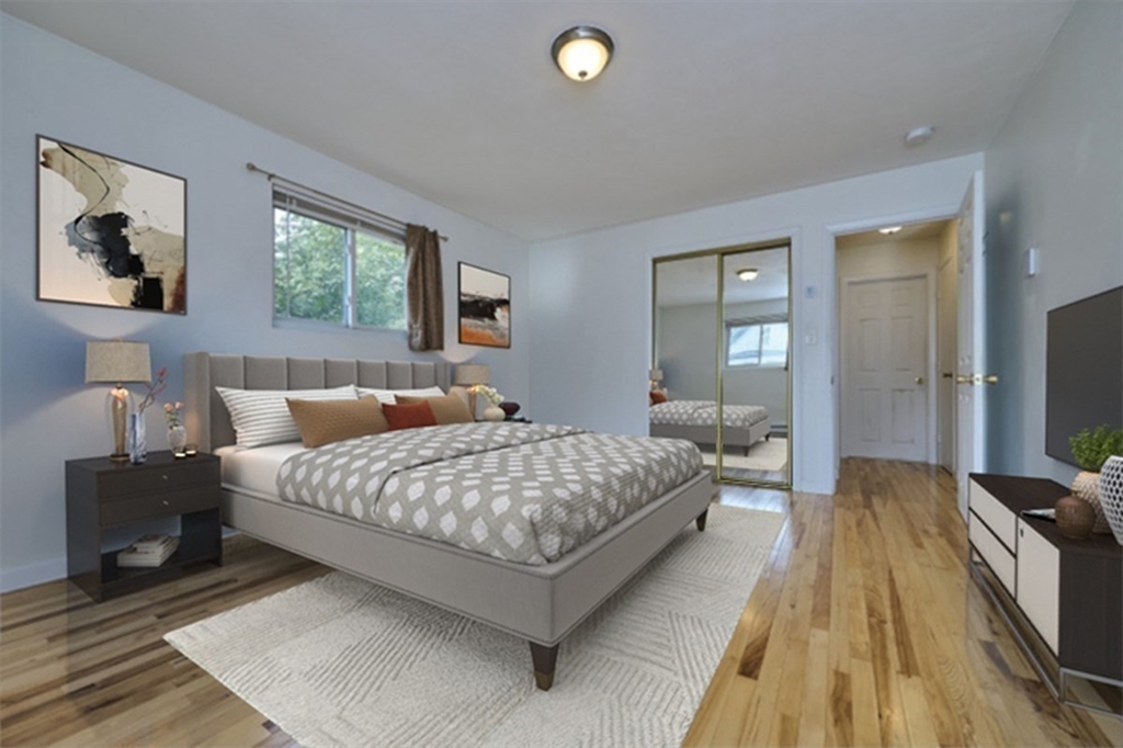 87 Cedar Street, Unit 10 Malden, MA 02148 - Photo 11 of 16 a bedroom with a bed and a flat screen tv