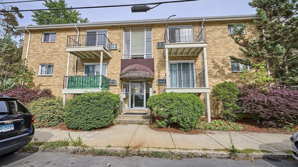 87 Cedar Street, Unit 10 Malden, MA 02148 - Photo 14 of 16 a front view of a house with garden