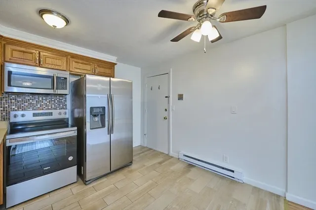 a view of a kitchen with a refrigerator and cabinets