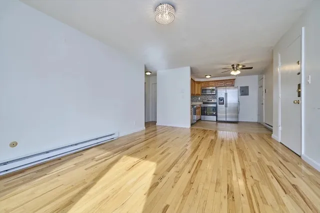 a view of empty room with wooden floor