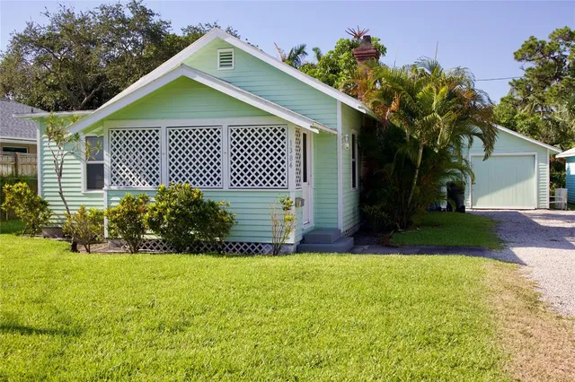an aerial view of a house with garden space and street view
