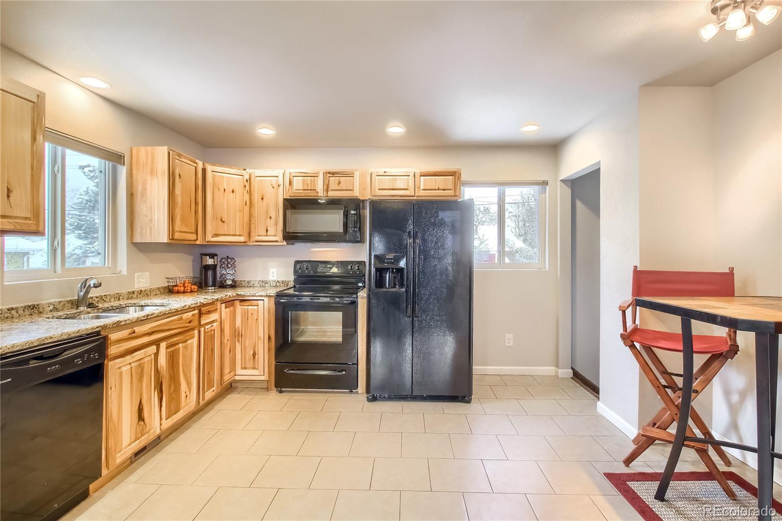 7545 Turner Drive Denver, CO 80221 - Photo 12 of 38 a kitchen with stainless steel appliances granite countertop a refrigerator and a stove top oven