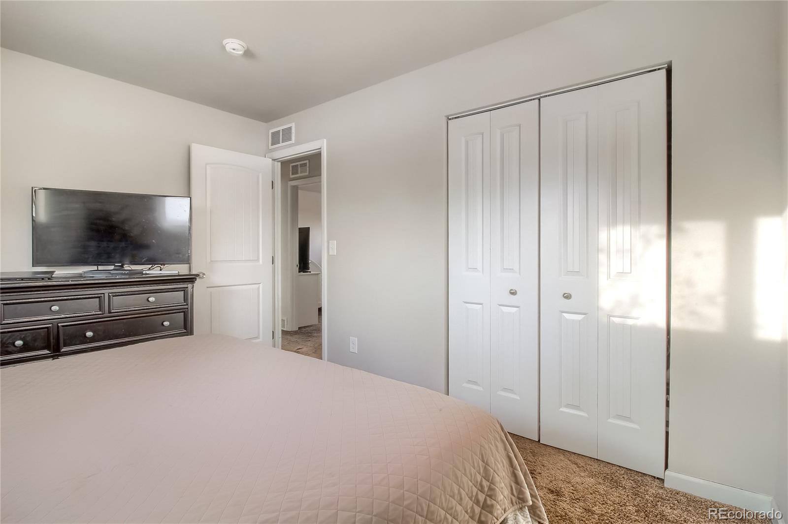 7545 Turner Drive Denver, CO 80221 - Photo 15 of 38 a bedroom with a bed and a flat screen tv