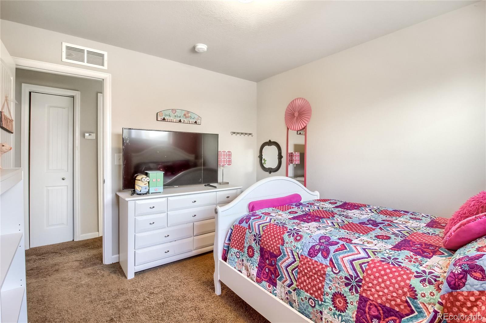 7545 Turner Drive Denver, CO 80221 - Photo 21 of 38 a bedroom with a bed and a flat screen tv