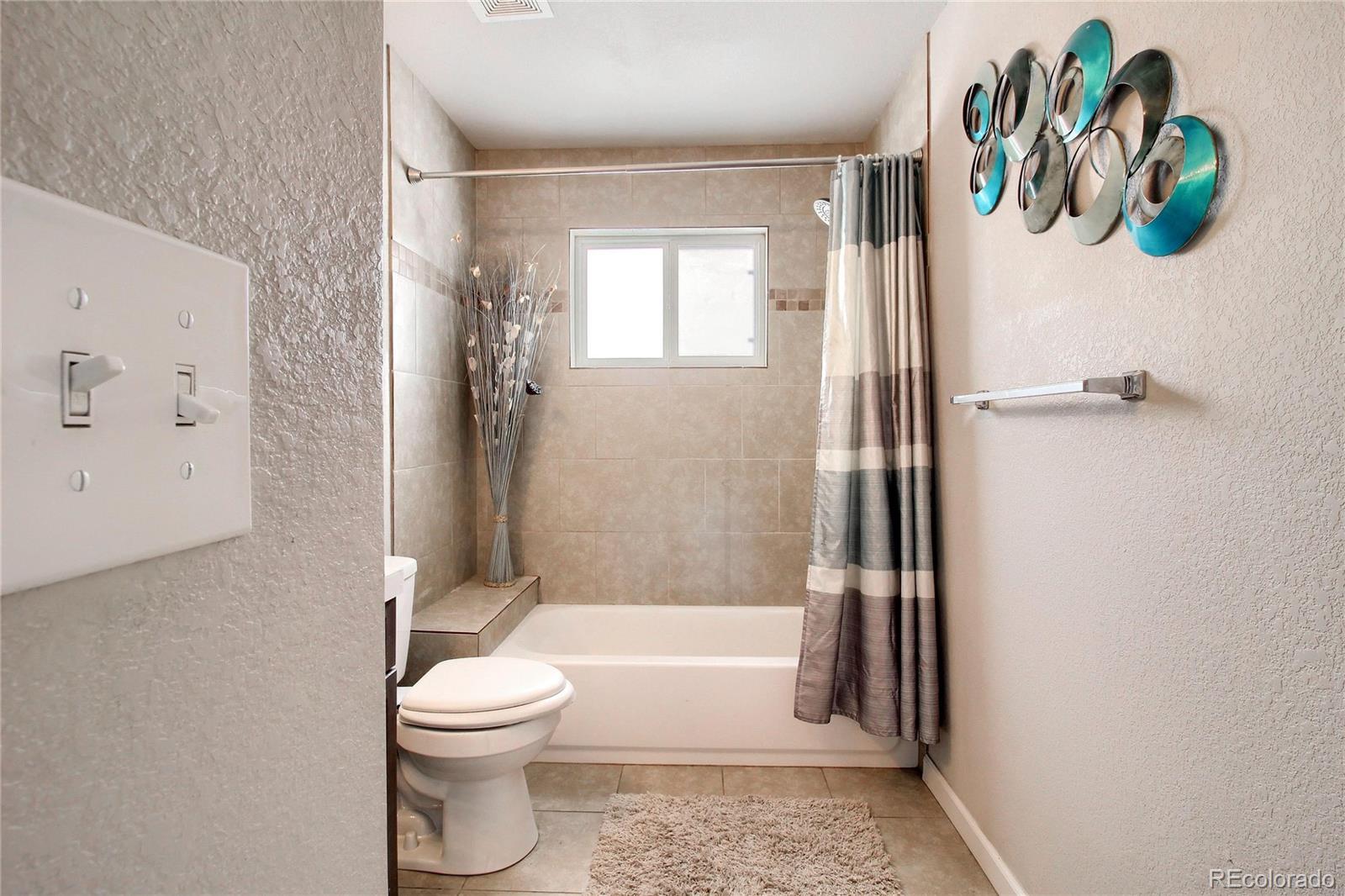 7545 Turner Drive Denver, CO 80221 - Photo 23 of 38 a bathroom with a toilet and a shower