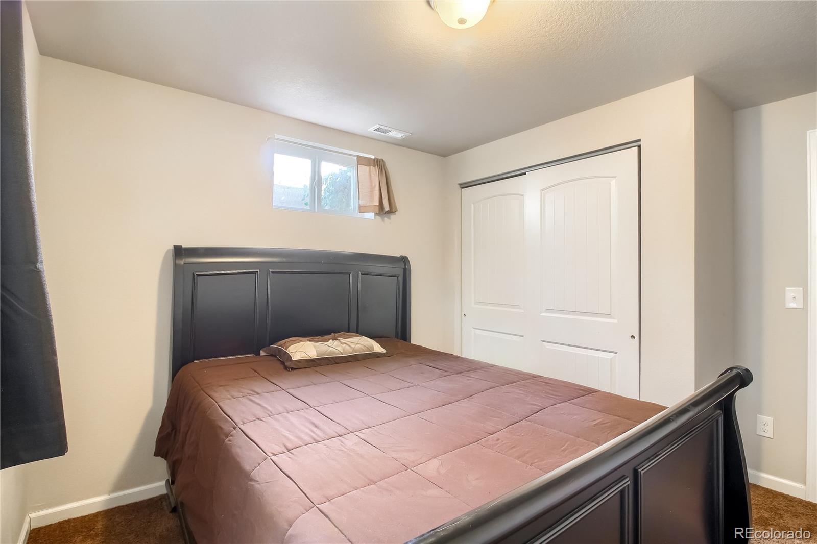 7545 Turner Drive Denver, CO 80221 - Photo 24 of 38 a bedroom with a bed and window