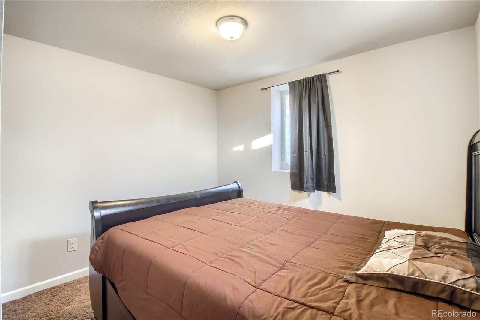 7545 Turner Drive Denver, CO 80221 - Photo 25 of 38 a bedroom with a bed and a window