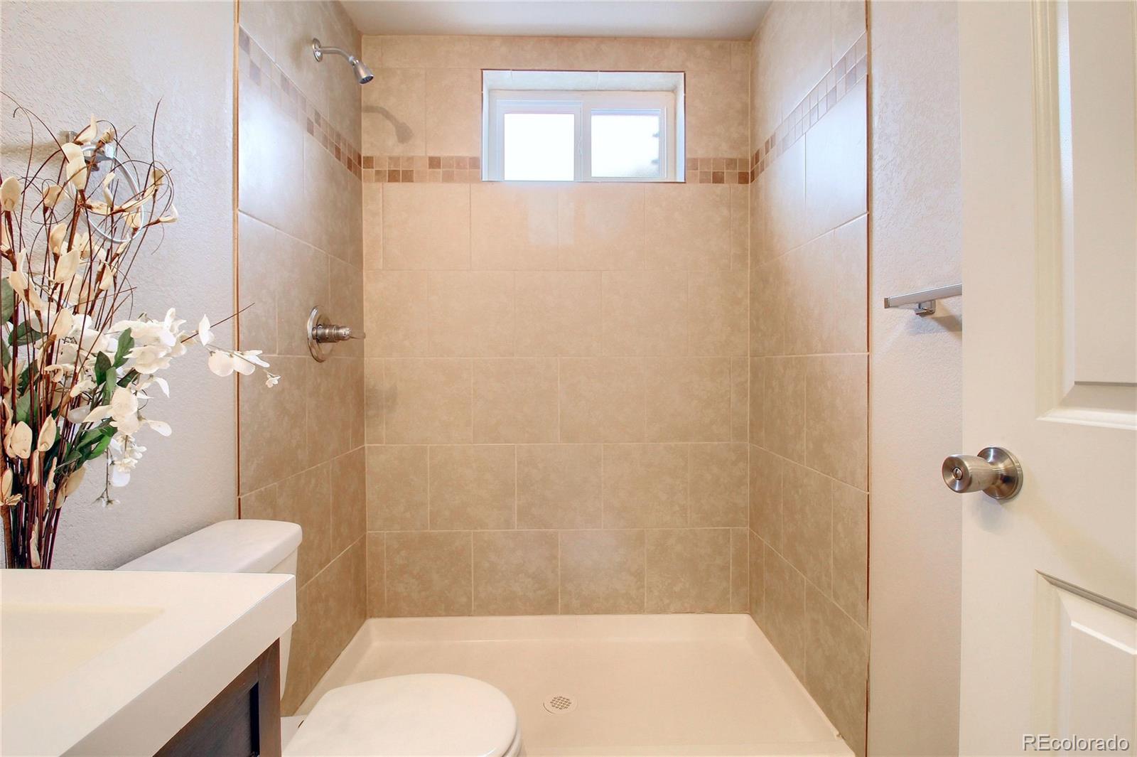 7545 Turner Drive Denver, CO 80221 - Photo 30 of 38 a bathroom with a sink toilet and shower
