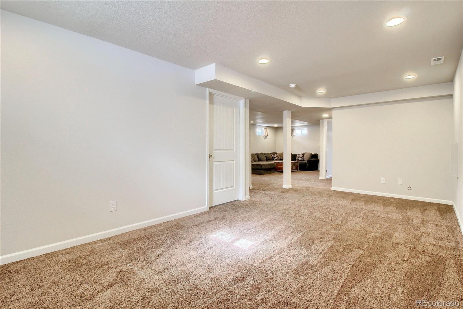 7545 Turner Drive Denver, CO 80221 - Photo 34 of 38 a view of a big room with wooden floor and a window