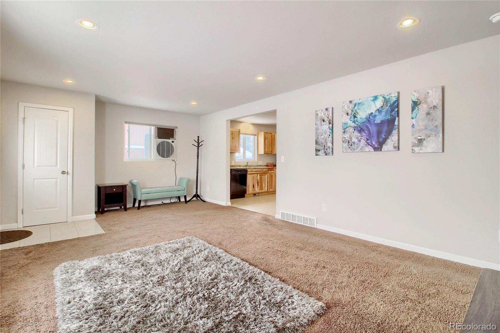 7545 Turner Drive Denver, CO 80221 - Photo 6 of 38 a view of a livingroom with wooden floor and kitchen space
