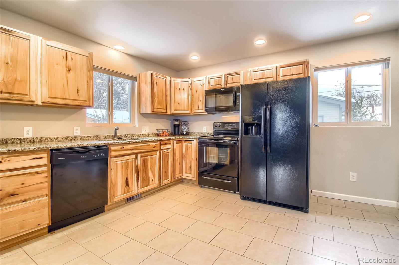7545 Turner Drive Denver, CO 80221 - Photo 7 of 38 a kitchen with stainless steel appliances granite countertop a refrigerator and a stove top oven
