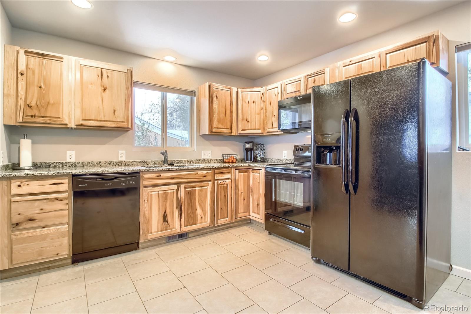 7545 Turner Drive Denver, CO 80221 - Photo 8 of 38 a kitchen with granite countertop a refrigerator sink and cabinets