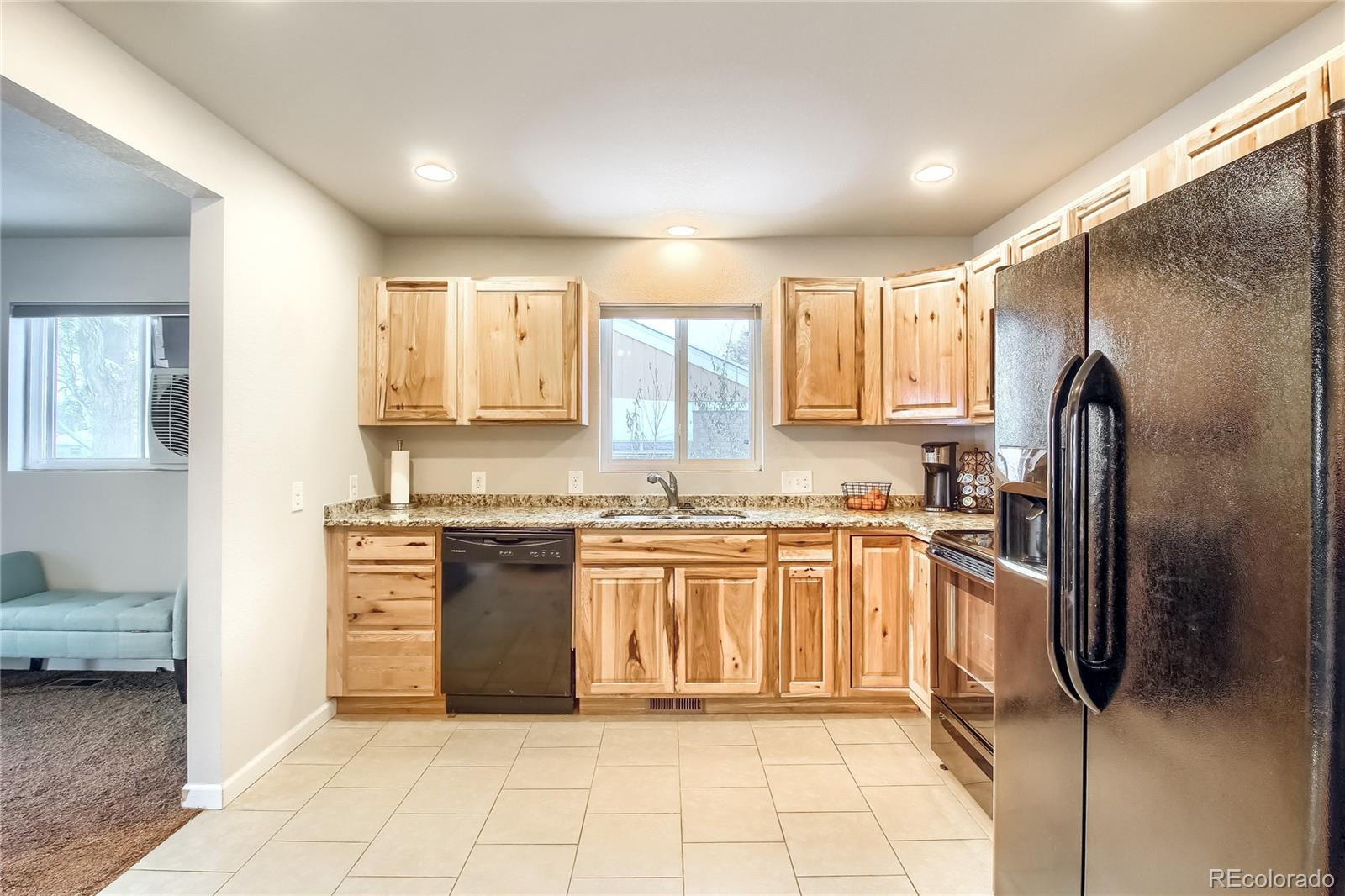 7545 Turner Drive Denver, CO 80221 - Photo 9 of 38 a kitchen with stainless steel appliances granite countertop a refrigerator and a stove top oven