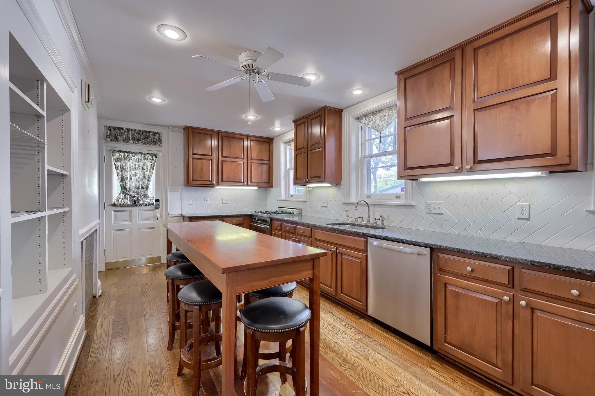 146 East Springettsbury Avenue York, PA 17403 - Photo 15 of 47 a kitchen with granite countertop a sink and wooden cabinets