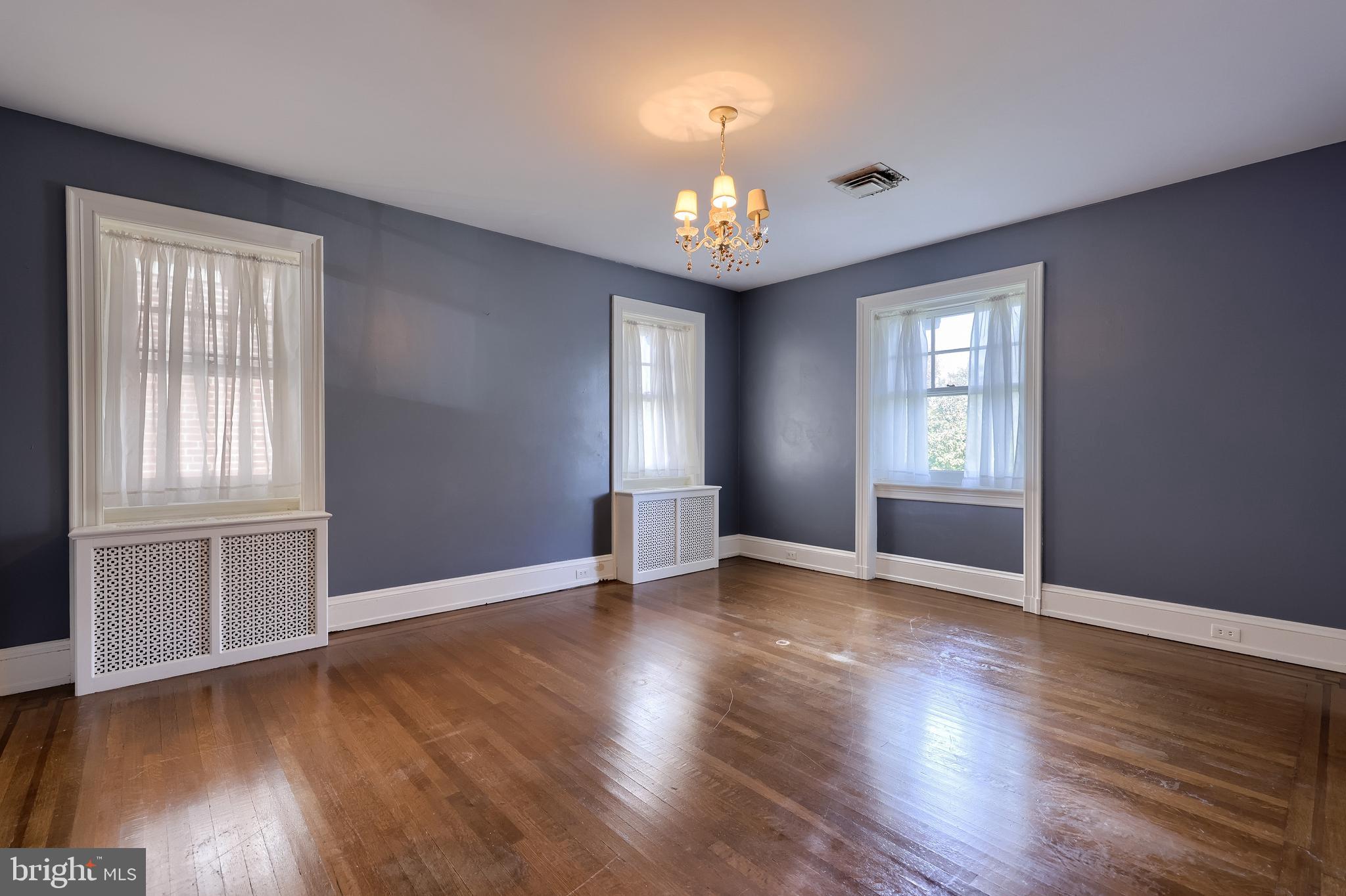 146 East Springettsbury Avenue York, PA 17403 - Photo 28 of 47 an empty room with wooden floor and windows