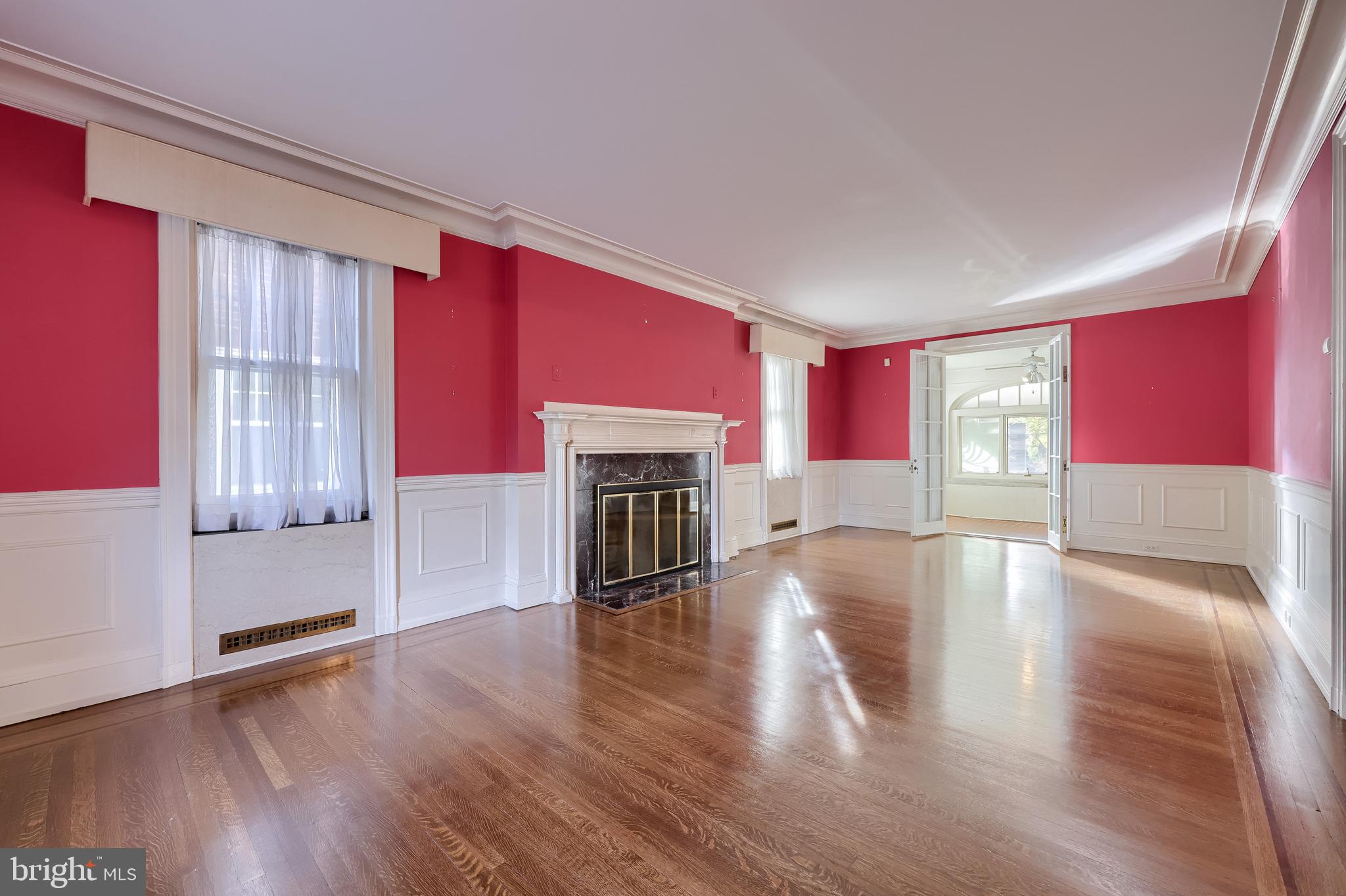 146 East Springettsbury Avenue York, PA 17403 - Photo 5 of 47 a view of empty room with wooden floor and fireplace