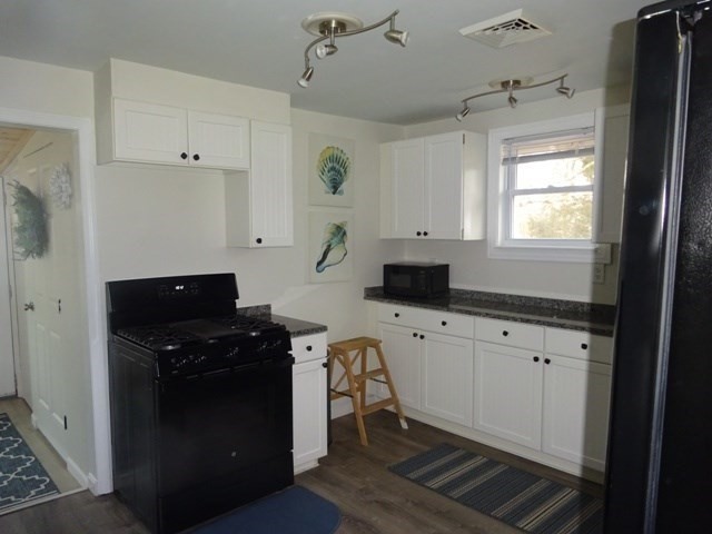 83 Shore Avenue, Unit 83 Wareham, MA 02571 - Photo 11 of 32 a kitchen with cabinets appliances and a window