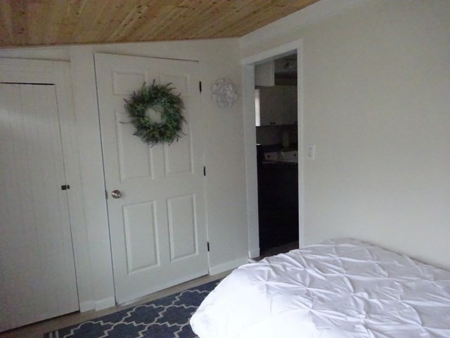 83 Shore Avenue, Unit 83 Wareham, MA 02571 - Photo 17 of 32 a bedroom with a bed and a hallway