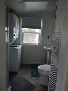 83 Shore Avenue, Unit 83 Wareham, MA 02571 - Photo 19 of 32 a bathroom with a toilet a sink and mirror