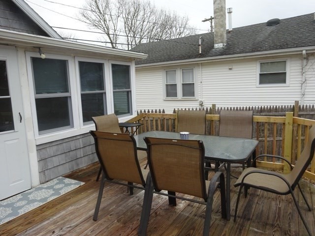 83 Shore Avenue, Unit 83 Wareham, MA 02571 - Photo 22 of 32 a view of a chairs and table on the deck