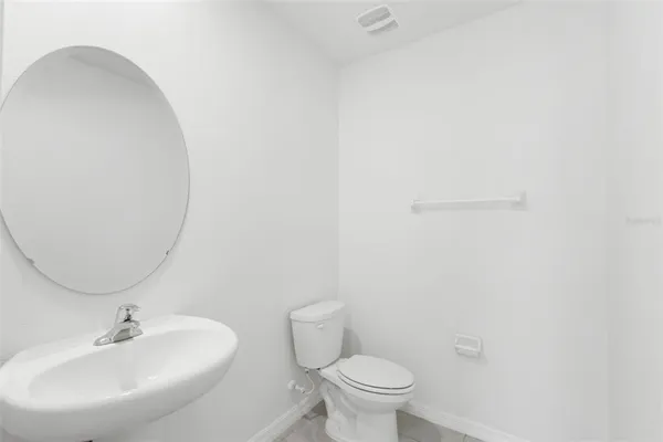 a bathroom with a sink a toilet and mirror