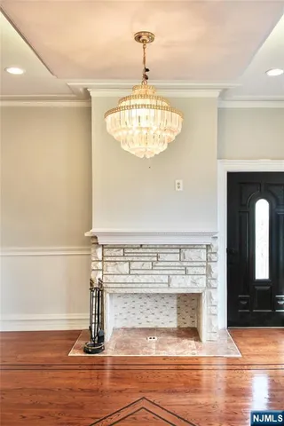 a view of a livingroom with wooden floor and a fireplace