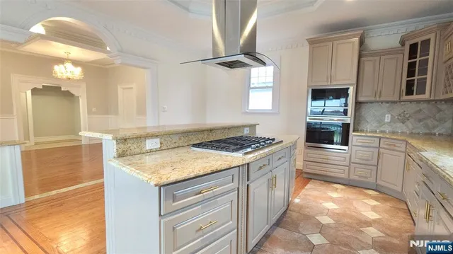 a kitchen that has a sink and a stove in it