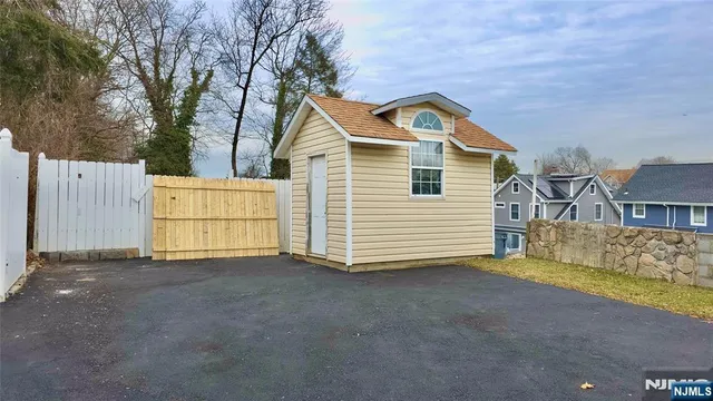 a view of a house with a yard and garage