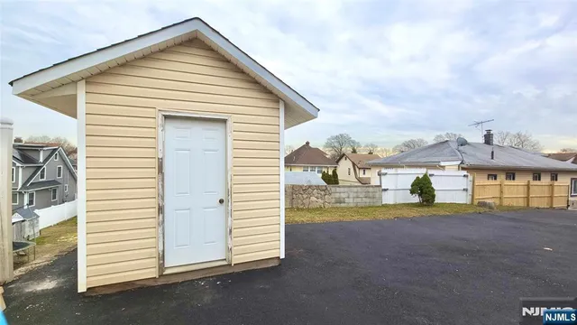 a view of a house with a yard and fence