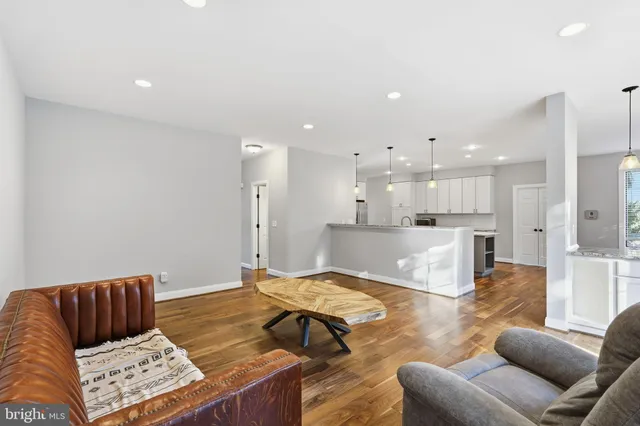a living room with furniture and kitchen view