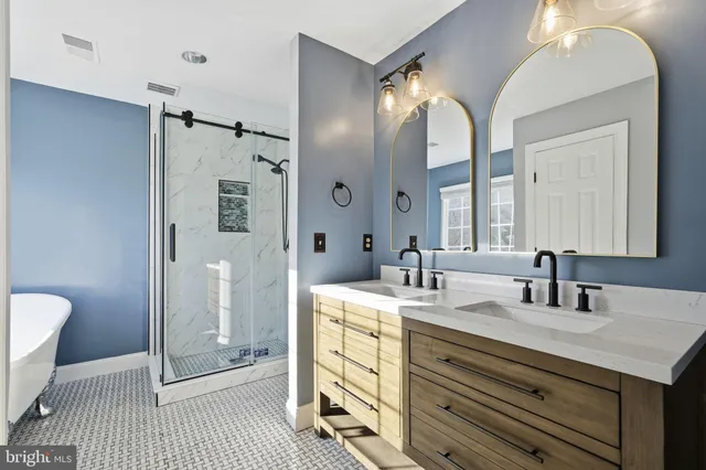 a bathroom with a double vanity sink mirror and toilet