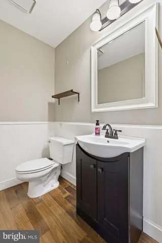 a bathroom with a sink toilet and mirror