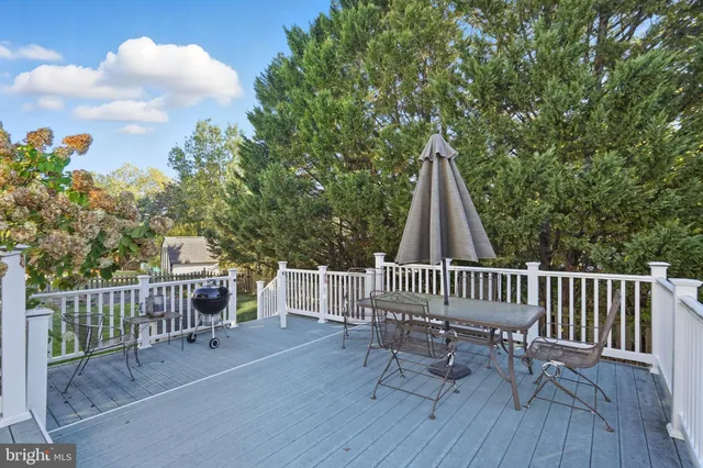 a view of balcony with wooden floor and outdoor seating